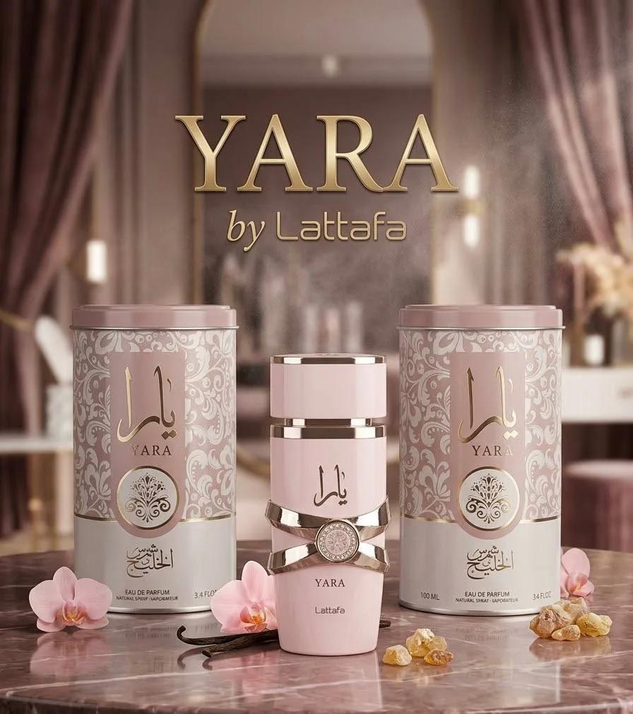 عطر يارا لطافة الوردي مع العبوات الأسطوانية وزهور الأوركيد على طاولة رخامية